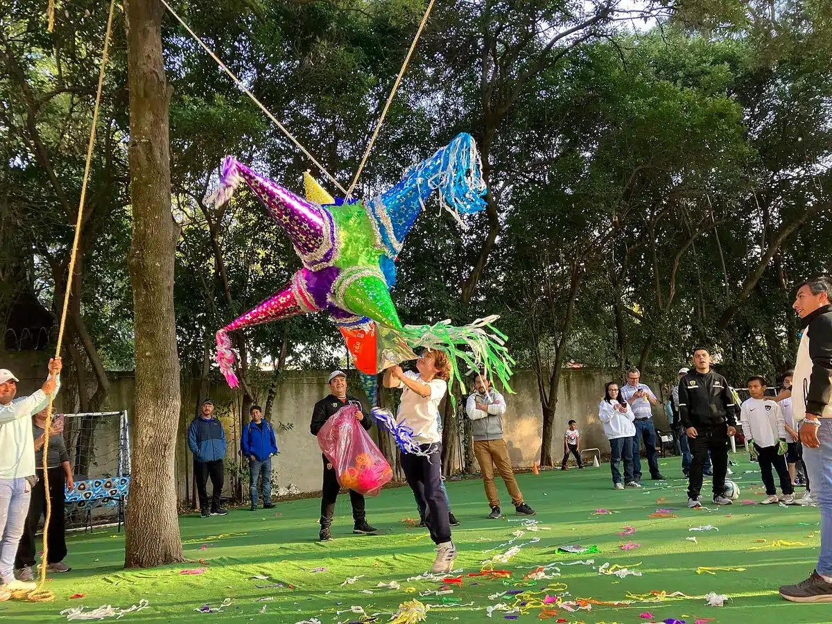 A filled star piñata suspended for a strike-to-break activity at a traditional Mexican Posada